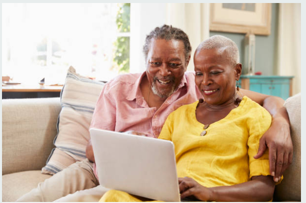 Older African learners using a laptop together