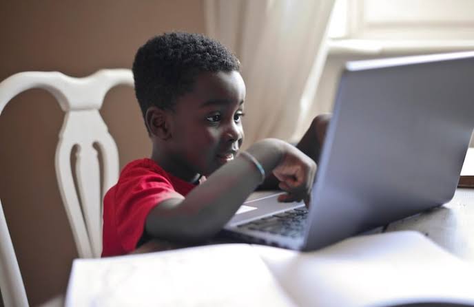 Young African learner using a laptop